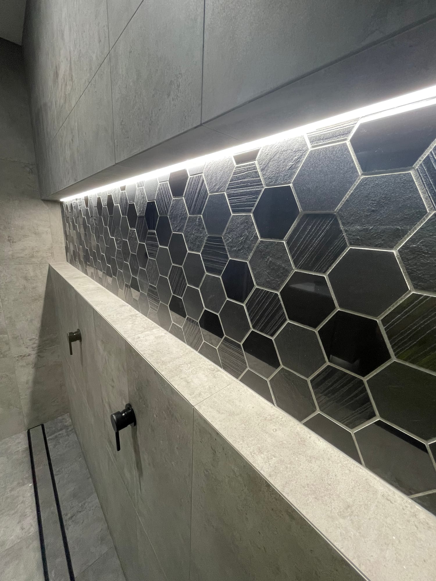 Shower with hexagon feature tiles and an LED-lit niche
